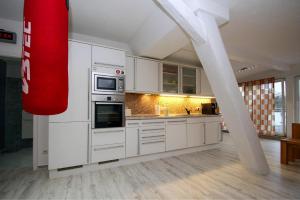 una cocina con armarios blancos y un horno de fogón blanco en Apartment SL Lounge, Luebben en Lübben