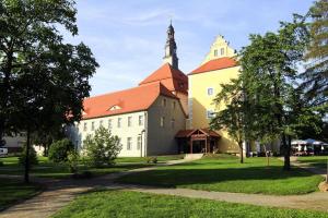 a large building with a tower and a church at Apartment SL Lounge, Luebben in Lübben