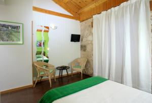 a bedroom with a bed and a table and chairs at El Lagar de La Navazuela in La Rasa +64 photos