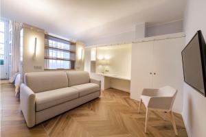 a living room with a couch and a tv at Hotel Baylle in Cagliari