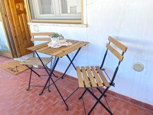 una mesa de picnic y dos sillas junto a una ventana en Appartamento Indipendente al Mare Sweet Apartments en Santa Marinella