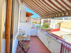 a small balcony with a table and chairs on it at Appartamento Indipendente al Mare Sweet Apartments in Santa Marinella