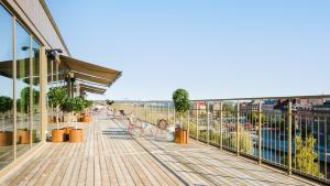 a boardwalk next to a building with people on it at Clarion Hotel Sundsvall in Sundsvall