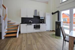 a kitchen with a stove and a staircase in a room at Apartment Hafenflair am Plauer See, Plau am See in Plau am See