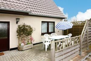 a patio with a table and chairs and an umbrella at House, Tessmannsdorf in Teßmannsdorf