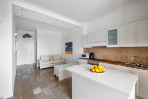 a kitchen with white cabinets and a white counter top at Casa Malu in Positano