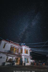 a building with the milky way in the sky at The Alpinist cafe and Retreat in Kaza