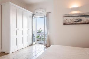 a bedroom with a bed and a door to a balcony at Casa Malu in Positano