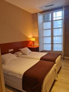 Cama o camas de una habitación en Hotel Montes
