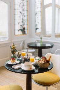 a breakfast table with a tray of food and orange juice at La Course in Bordeaux