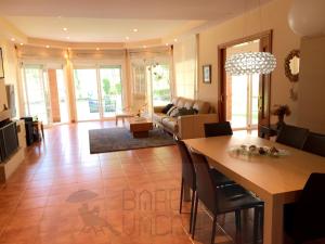 a living room with a table and a couch at BarcelonaVacances-Villa Lucia in San Pol de Mar