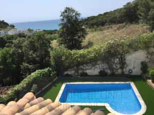 an aerial view of a swimming pool in a garden at BarcelonaVacances-Villa Lucia in San Pol de Mar