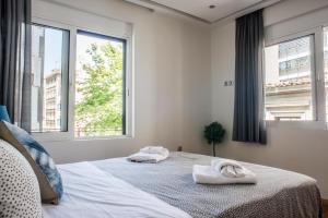 A bed or beds in a room at A23 Premium suite with balcony near Parthenon
