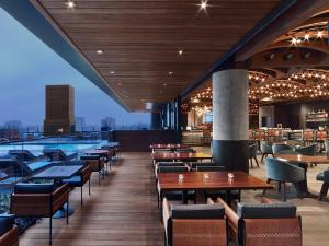a restaurant with tables and chairs and a pool at Hotel Van Zandt in Austin