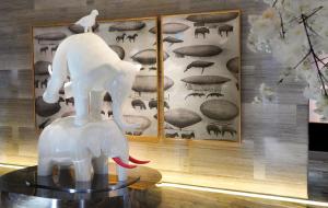 a white elephant statue sitting on top of a table at Boda Hotel in Taichung