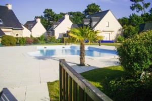 a swimming pool in a house with a palm tree at Holiday Home in Erquy near Sandy Beaches in Erquy