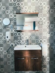 a bathroom with a sink and a mirror at Auberge Des Pins in Tourrettes