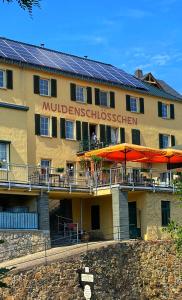 a building with solar panels on the side of it at Das Muldenschlösschen - Gästehaus & Restaurant in Lunzenau
