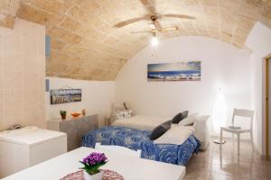 a bedroom with a bed and a table in a room at Monopoli Heartbeat - Apartment 200m from Sea in Monopoli