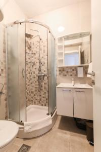 a bathroom with a shower and a toilet and a sink at Apartments Viola in Tučepi +60 photos