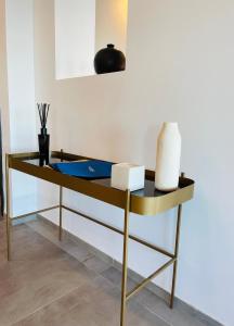 a yellow and black table with a roll of paper on it at Hotel VIU57 in Mellieħa