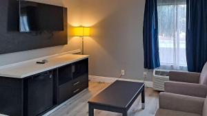 a living room with a tv and a coffee table at Clarion Pointe El Cajon San Diego East in El Cajon