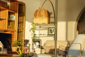 a room with a shelf with a lamp and a cat at Private rooms in seafront apartment in Sliema