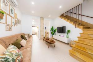 a living room with a couch and a staircase at Ca Na Lola in Porto Cristo