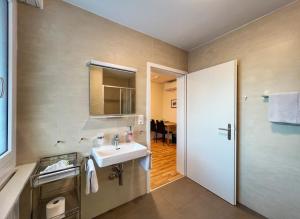 bagno con lavandino e specchio di Hotel Hecht a Rheineck