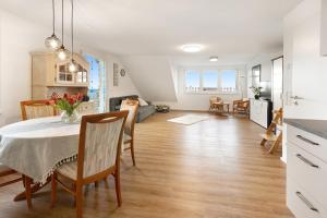 a kitchen and living room with a table and chairs at kleine Auszeit in Albbruck