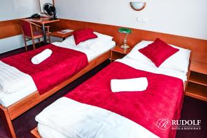 Postel nebo postele na pokoji v ubytování Hotel Rudolf
