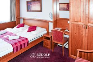 Postel nebo postele na pokoji v ubytování Hotel Rudolf