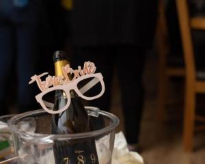 a bottle of champagne with a pair of glasses at Fullers Hill Cottages in Little Grandsen