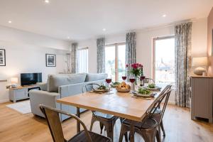 a living room with a table and a couch at 2 Deben Wharf Woodbridge Air Manage Suffolk in Woodbridge