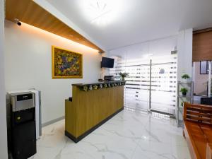 a lobby with a bar in a building at OYO 848 Dona Aurora Condotel in Manila