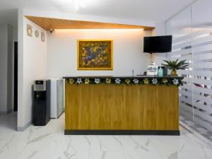 a lobby with a reception counter with flowers on it at OYO 848 Dona Aurora Condotel in Manila