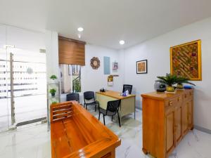 ein Büro mit einem Schreibtisch und Stühlen in einem Zimmer in der Unterkunft OYO 848 Dona Aurora Condotel in Manila