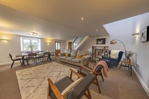 a living room with a couch and a table at 3 Bedroom Barn Conversion -Garden View - Ty Cerrig Barn in Corwen