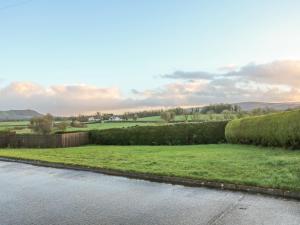 a view of a grassy field and a river at Derryallen View in Enniskillen