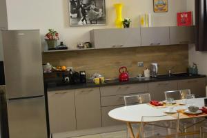 a kitchen with a table and a refrigerator at Amphitheatrum Arena in Verona