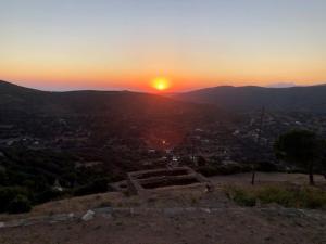 a view of the sunset from the top of a mountain at Lydia's house in Révmata