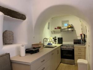a kitchen with a counter with a sink and a stove at Lydia's house in Révmata