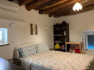a bedroom with a bed and a book shelf at Lydia's house in Révmata