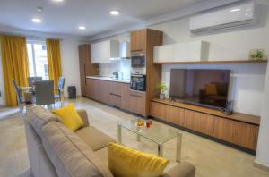 a living room with a couch and a large tv at Spacious and tastefully furnished 2 bedroom apartment DDIF1-3 in Il-Gżira
