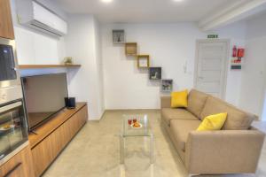 a living room with a couch and a tv at Spacious and tastefully furnished 2 bedroom apartment DDIF1-3 in Il-Gżira