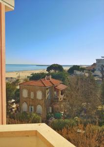 a view of a house with the ocean in the background at Hotel Royal in Giulianova