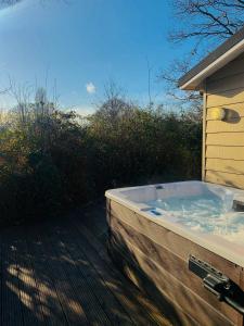 a bath tub sitting on the side of a house at Golden Cross Holiday Park in Hailsham