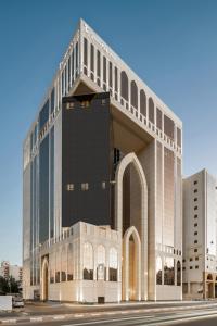 a large office building with a large building at Wirgan Hotel Al Azizyah in Makkah