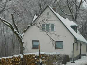 a white house with a snow covered roof at Haus Eugen in Presseck