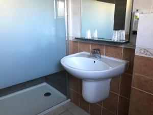 a bathroom with a sink and a bath tub at Logis - Hostellerie Le Chatel Nangis in Nangis